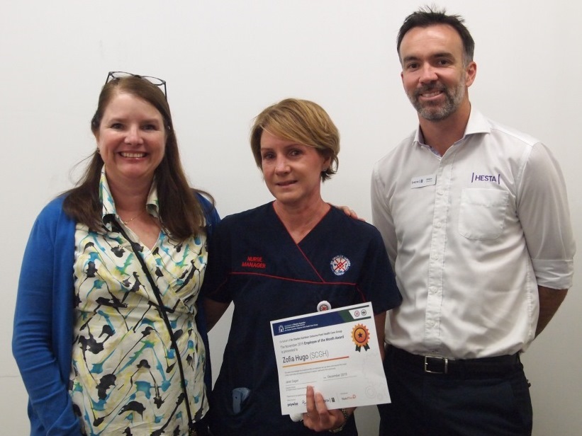 Acting Nurse Manager for Wards G52 and G66 Zofia Hugo (centre) with Deputy Nurse Co-Director Surgical Division Lara Vasta, and Emlyn Whetnall from HESTA who kindly brought cake for all to share.