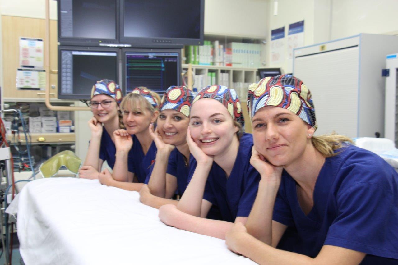 Theatres team with caps featuring Aboriginal design