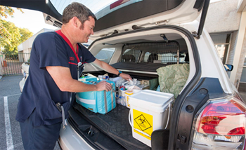 Home Link nurse packing equipment in the boot of the car